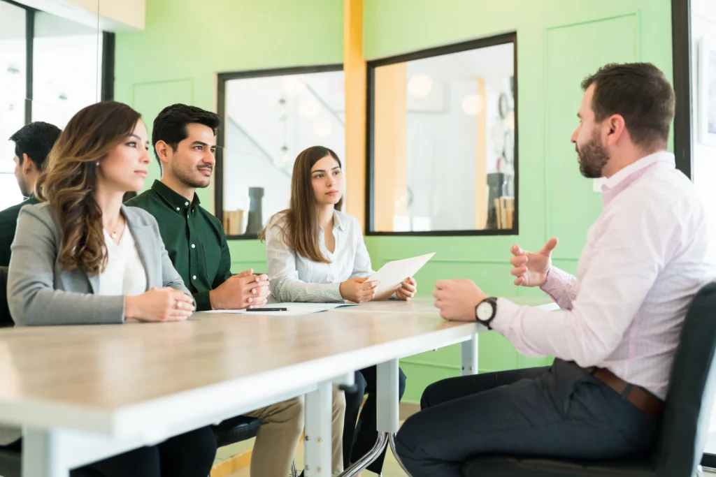 Un candidato es entrevistado por un panel de tres reclutadores, como parte del proceso de selección de personal.